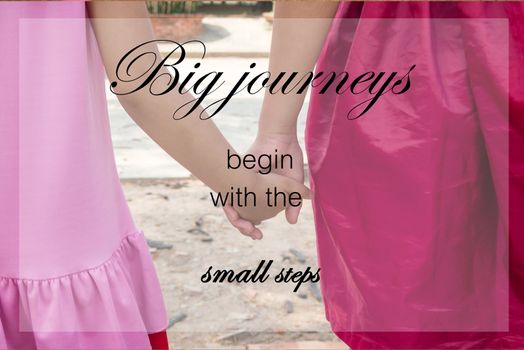 Word  Big journeys begin with the small steps.Inspirational motivational quote on little kids couple holding hands background