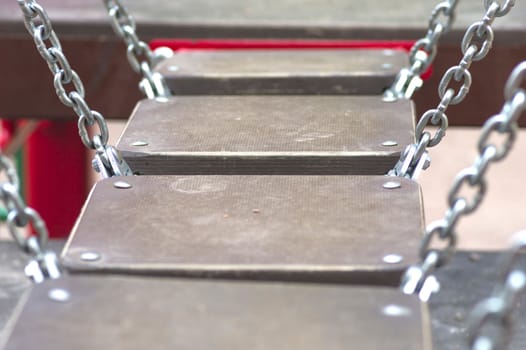bridge on the chains of the wooden planks on the playground