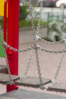 bridge on the chains of the wooden planks on the playground