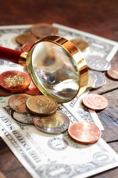 Financial concept. Magnifying glass on various world currency closeup