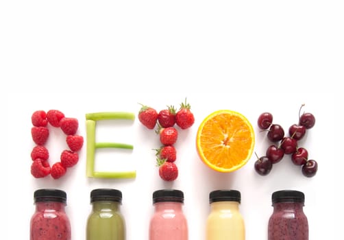 Detox word made with fruits from assorted fruit smoothies over a white background 