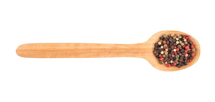 Colored pepper on a wooden spoon isolated on white