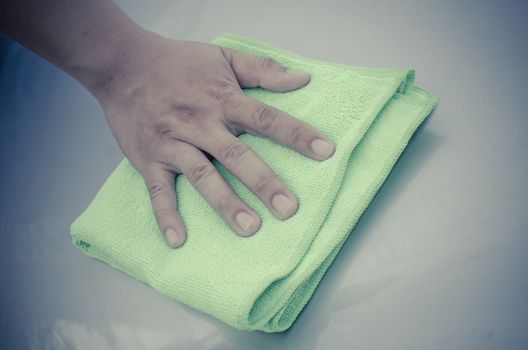 A man cleaning car with microfiber cloth