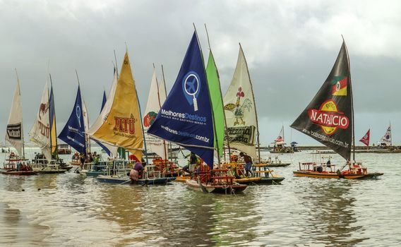 Pernambuco, Brazil July 6, 2016: An unidentified group of people in Chicken Beach with typical sail boats in Ipojuca City, northeast Brazil