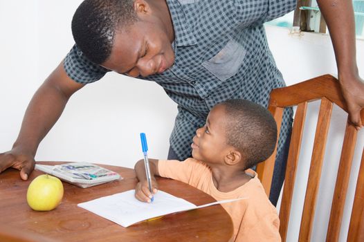 The teacher explains something to the schoolboy looking at his face.