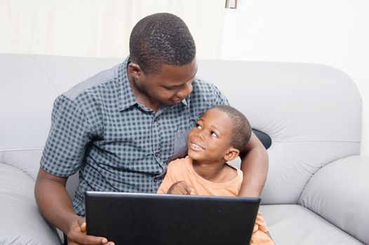 The father is happy to see his child to know and work with a laptop.
