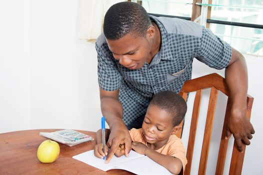 The father said to his child to write on the line of his copy book.