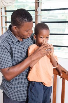 This  child loves his father to give him water to drink.