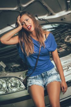 Beautiful girl is desperate when realizing that her car broke down. 