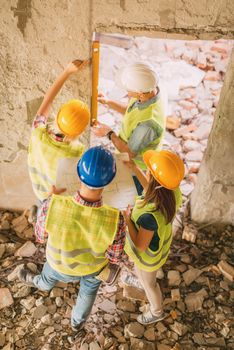 Four construction architects review building damaged in the disaster.