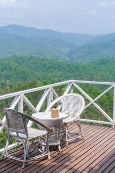 rattan chair on balcony with beautiful mountain view