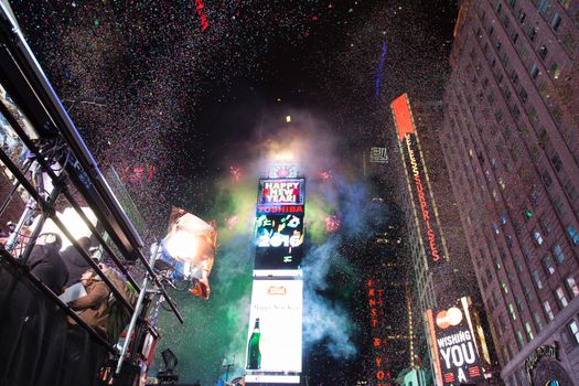 UNITED STATES, New York: Confetti fly over the Time Square after the clock strikes midnight during the new year celebrations on January 1, 2016 in New York City.