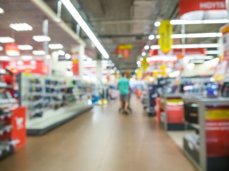 Blur eletronic department store with unrecognizable customers. Blurred background with bokeh