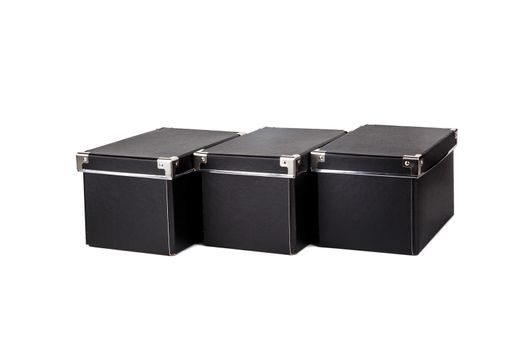 Close up view of three black cardboard box isolated on white background.