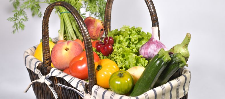 Fruit and vegetable in a basket, white background