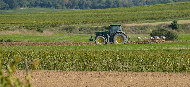 Tractor plowing the fields Champagne France Europe