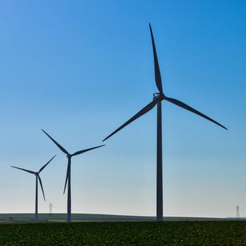 Windmills for electric power production on blue sky, France, Europe