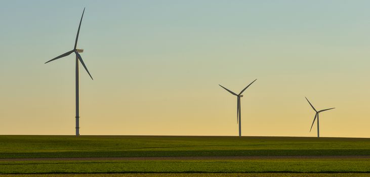 Windmills for electric power production on blue sky, France, Europe