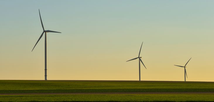 Windmills for electric power production on blue sky, France, Europe