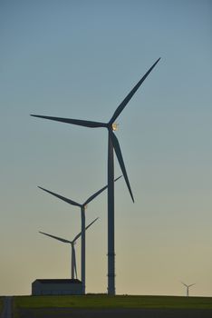 Windmills for electric power production on blue sky, France, Europe