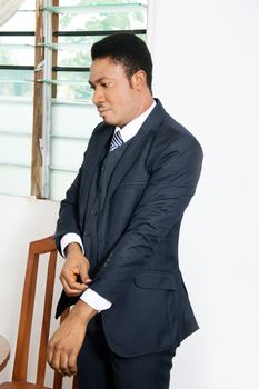 this businessman is being well arrange the sleeve of his suit