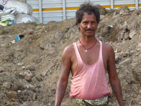 A portrait of a poor Indian man who works on a construction site