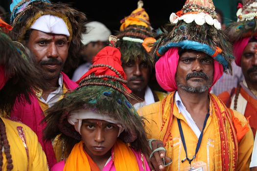 A groups of pilgims traditionally called as Vasudevs wearing their typical peacock feather hat.