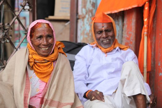 A portrait of an old pilgrim woman smiling happily during an Indian pilgrimmage.