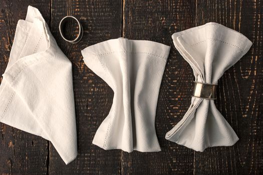 Set of the napkins with vintage ring on the wooden table horizontal