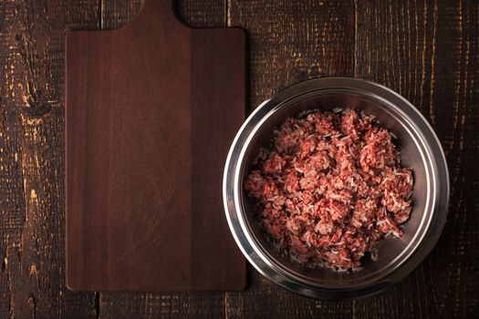 Ground beef with rice in the metal pan  on the wooden table top view