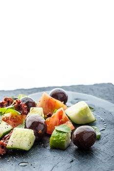 Vegetable salad on the black stone table