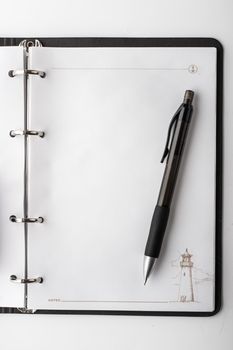 Open clear notebook and pen  vertical