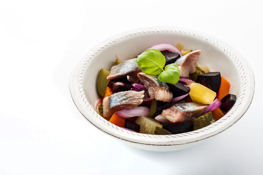 Salad with beet and herring on the white background