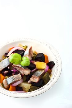 Beet and herring salad on the white dish vertical