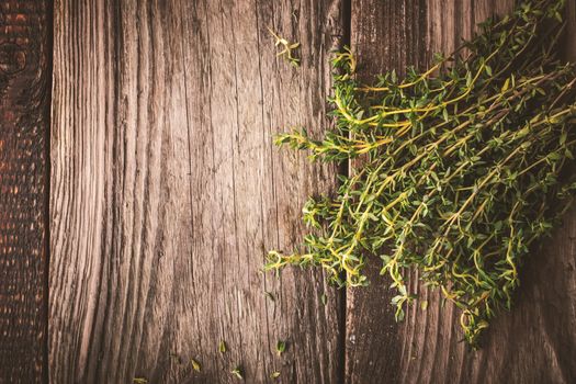 Bundle of thyme on the wooden board top view