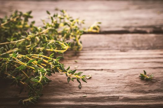 Bundle of thyme on the old wooden board