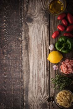 Vegetable with seasoning , shrimps and pasta on the wooden table vertical
