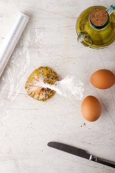 Raw egg  with herbs in the transparent bag