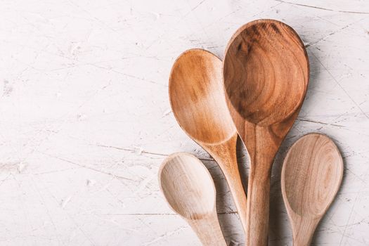 Different wooden spoons  on the white table