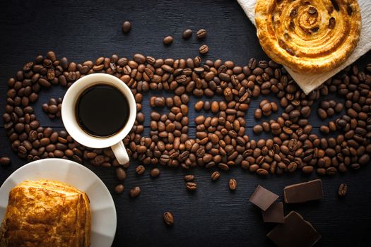 Coffee word made by coffee beans with  chocolate , pastry and cup of coffee