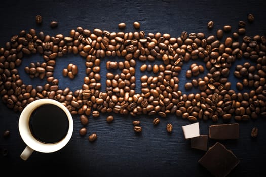 Coffee word made by coffee beans with chocolate and cup of coffee