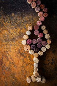 Glass of wine made by cork on the colorful background