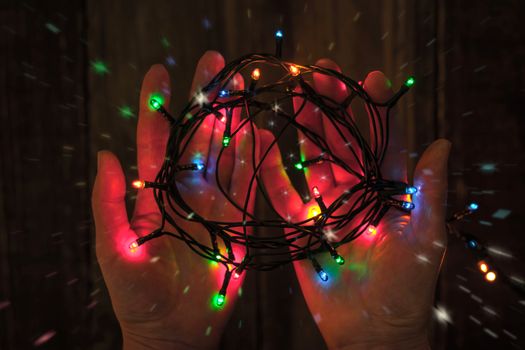 Shining colorful festoon in the hands