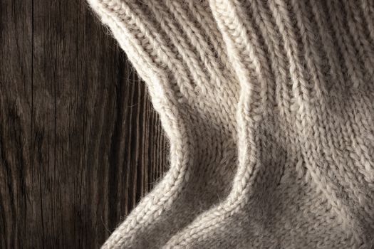 Knitted wool socks on the wooden background