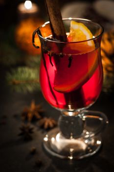 Mulled wine with spices and blurred Christmas decorations