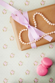 Gift box with pearls in a romantic vintage style in pastel colors vertical