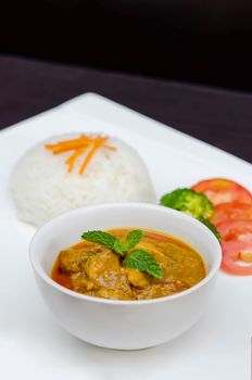 chicken tikka masala served with rice and vegetables