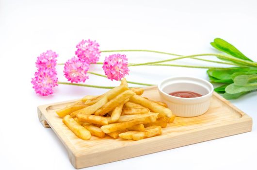 Traditional  French fries  on wooden plate with tomato sauce