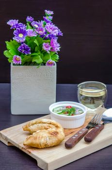 Curry puff pastry with sweet sauce  on wooden plate