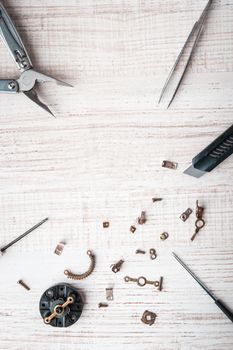 Tools and disassembled mechanism on the desktop vertical